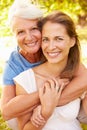 Senior woman sitting outdoors with her adult daughter Royalty Free Stock Photo