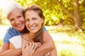 Senior woman sitting outdoors with her adult daughter Royalty Free Stock Photo