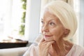 Senior Woman Sitting On Sofa At Home Suffering From Depression Royalty Free Stock Photo