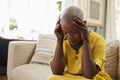 Senior Woman Sitting On Sofa At Home Suffering From Depression Royalty Free Stock Photo