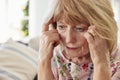 Senior Woman Sitting On Sofa At Home Suffering From Depression Royalty Free Stock Photo