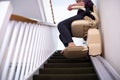 Detail Of Senior Woman Sitting On Stair Lift At Home To Help Mobility Royalty Free Stock Photo