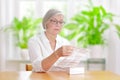 Woman reading drug package leaflet Royalty Free Stock Photo