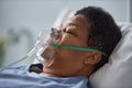 Senior woman sleeping on bed in hospital with oxygen support mask Royalty Free Stock Photo