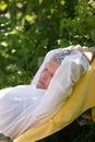 Senior woman sleeping on lounger Royalty Free Stock Photo