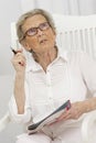 Senior woman sloving crosswords on a magazine Royalty Free Stock Photo