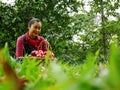 Senior woman smile portrait and holding red apple in garden park. Royalty Free Stock Photo