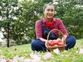 Senior woman smile portrait and holding red apple in garden park. Royalty Free Stock Photo