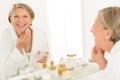 Senior woman smiling bathroom mirror reflection Royalty Free Stock Photo