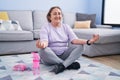 Senior woman smiling confident doing yoga exercise at home Royalty Free Stock Photo