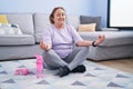 Senior woman smiling confident doing yoga exercise at home Royalty Free Stock Photo