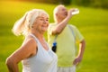 Senior woman smiling outdoors.