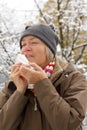 Senior woman sneezing outdoors winter Royalty Free Stock Photo