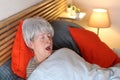 Senior woman snoring in bed