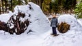 Senior woman snowshoeing at Sun Peaks village