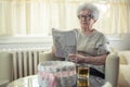 Senior woman solving a crossword puzzle at home. Royalty Free Stock Photo