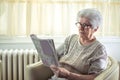 Senior woman solving a crossword puzzle at home. Royalty Free Stock Photo