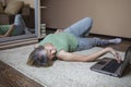 Senior woman in sportswear watching online video on laptop and doing fitness exercises at home Royalty Free Stock Photo