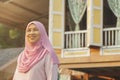 Senior woman standing in front of wooden house Royalty Free Stock Photo