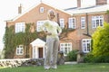 Senior Woman Standing Outside House