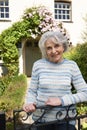 Senior Woman Standing Outside Pretty Cottage Royalty Free Stock Photo