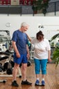 Senior woman stands on weight scale at gym. Royalty Free Stock Photo