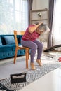 Senior woman stretch back muscles for exercise at home