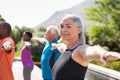 Senior woman stretching arms in yoga class