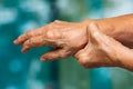 Senior woman stretching herself in bokeh blue swimming pool background, Close up & Macro shot, Selective focus, Healthcare concept Royalty Free Stock Photo