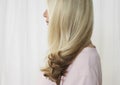 Senior woman in studio profile face obscured by hair