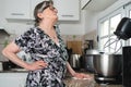 Senior woman suffering back pain while cleaning the kitchen Royalty Free Stock Photo