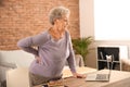 Senior woman suffering from back pain at home Royalty Free Stock Photo