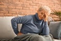 Senior woman suffering from back pain at home Royalty Free Stock Photo