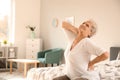 Senior woman suffering from back pain at home Royalty Free Stock Photo