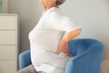 Senior woman suffering from back pain at home Royalty Free Stock Photo