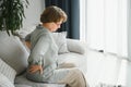 Senior woman suffering from back pain on sofa at home Royalty Free Stock Photo