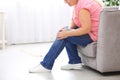 Senior woman suffering from knee pain at home, closeup. Royalty Free Stock Photo