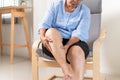 Senior woman suffering from knee pain at home, health problem concept Royalty Free Stock Photo