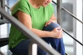 Senior woman suffering from knee pain indoors Royalty Free Stock Photo