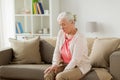 Senior woman suffering from pain in leg at home Royalty Free Stock Photo