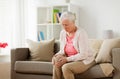 Senior woman suffering from pain in leg at home Royalty Free Stock Photo