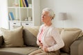 Senior woman suffering from stomach ache at home Royalty Free Stock Photo