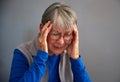 Senior Woman Suffering With Stress Or Headache At Home Holding Head In Pain Royalty Free Stock Photo