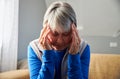 Senior Woman Suffering With Stress Or Headache At Home Holding Head In Pain Royalty Free Stock Photo