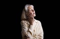 Senior woman suffering with toothache against black background Royalty Free Stock Photo