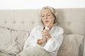 Senior woman suffering from toothache resting in bed Royalty Free Stock Photo