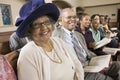 Senior Woman in Sunday Best among congregation at Church portrait Royalty Free Stock Photo