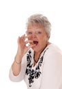 Senior woman swallowing vitamin pill. Royalty Free Stock Photo