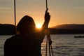 Senior woman on swing with sunset