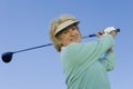 Senior Woman Swinging A Golf Club